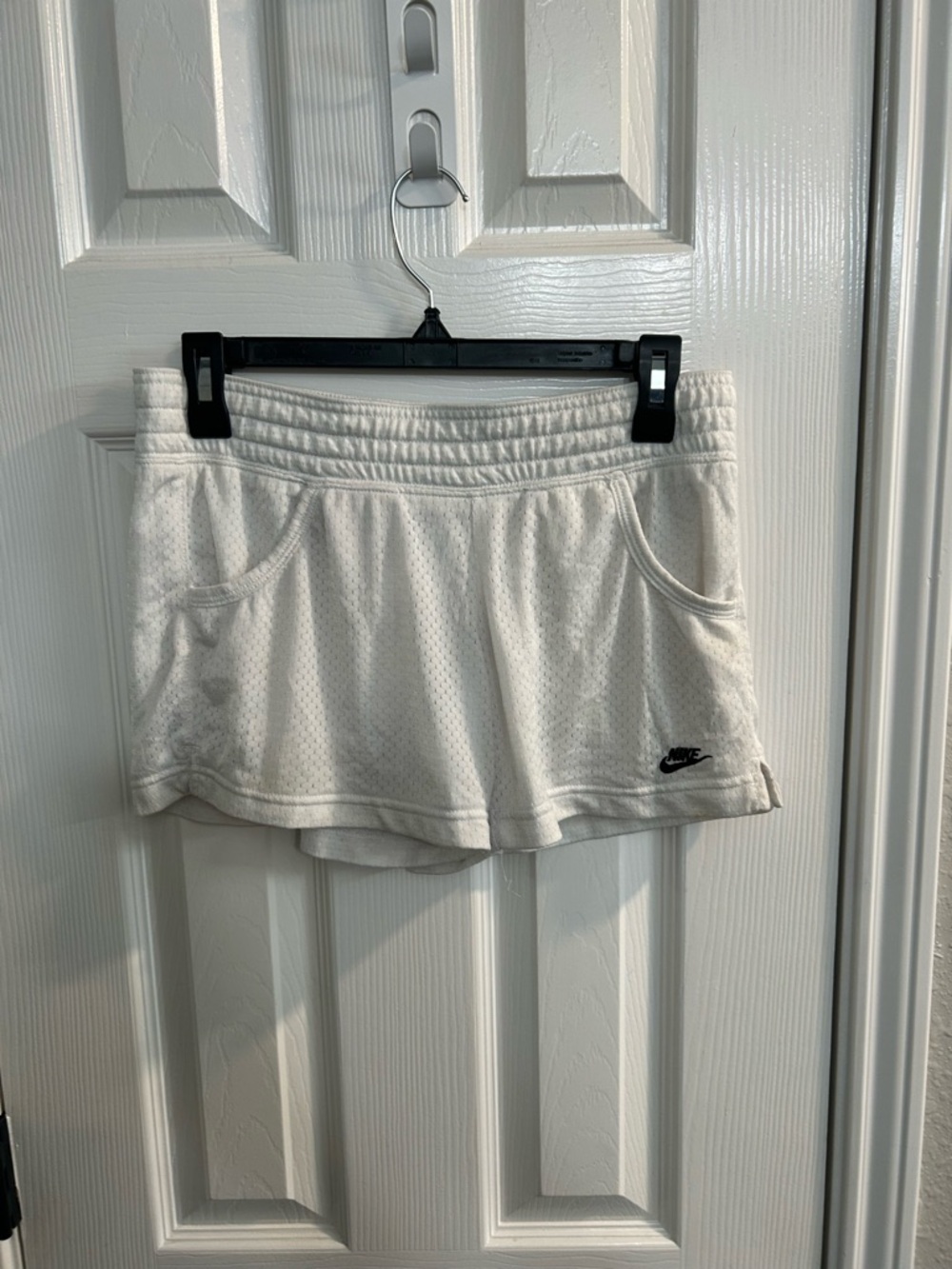 Women’s size small white Nike athletic shorts black logo